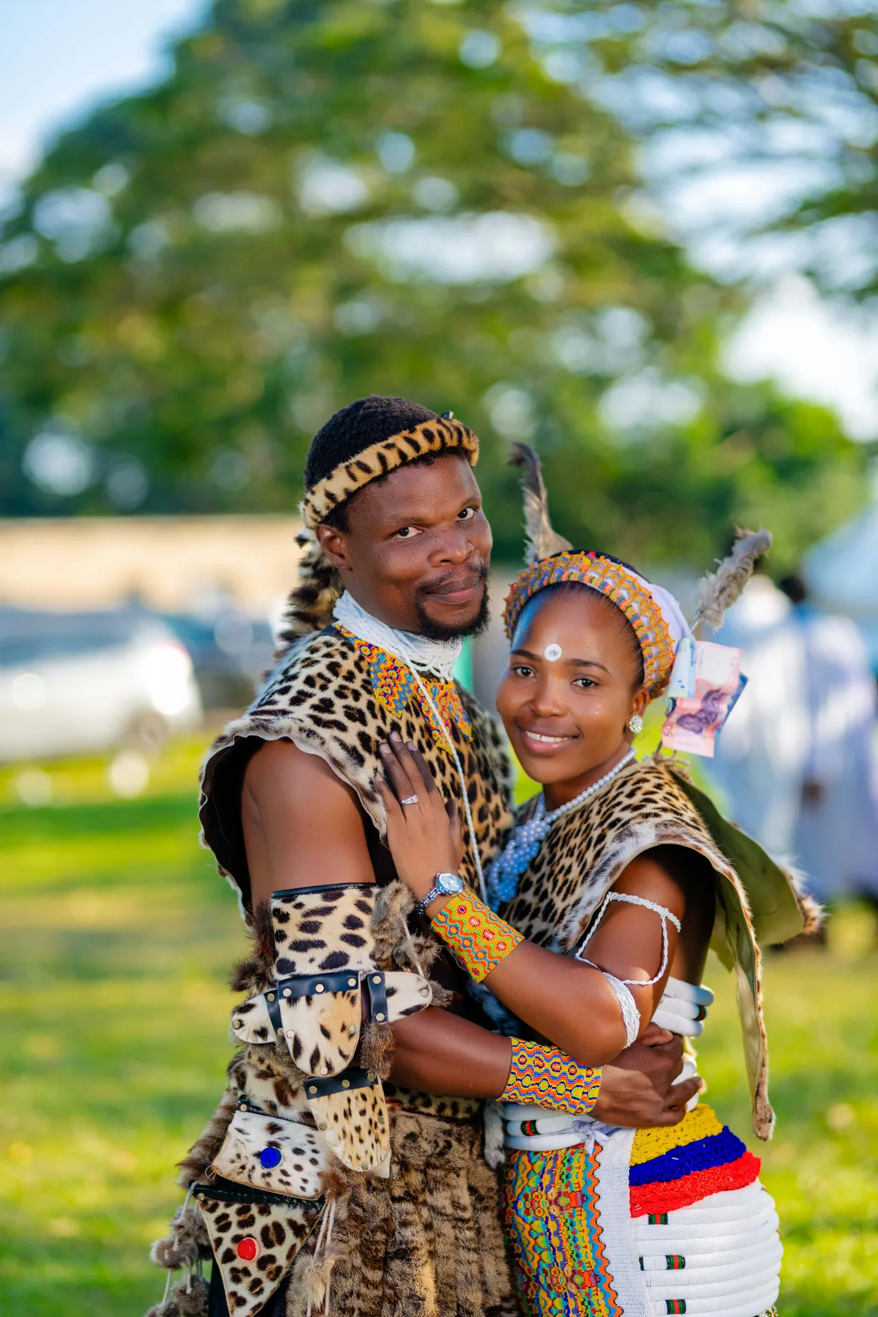 Couple celebrating in traditional attire outdoors